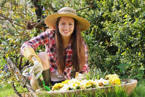 Professional gardener trimming hedges in Neasden